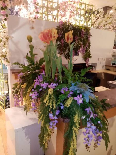 L'accueil au comptoir est fleuri dans les couleurs du printemps.